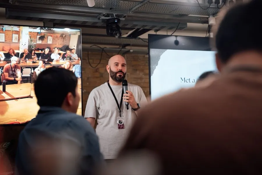 A speaker presenting to a room of people.